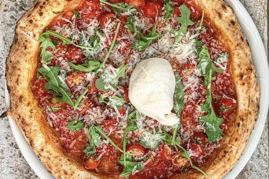 Wood-fired pizza with tomato, arugula, parmesan and burrata at Cibo Urban Pizzeria in downtown Phoenix