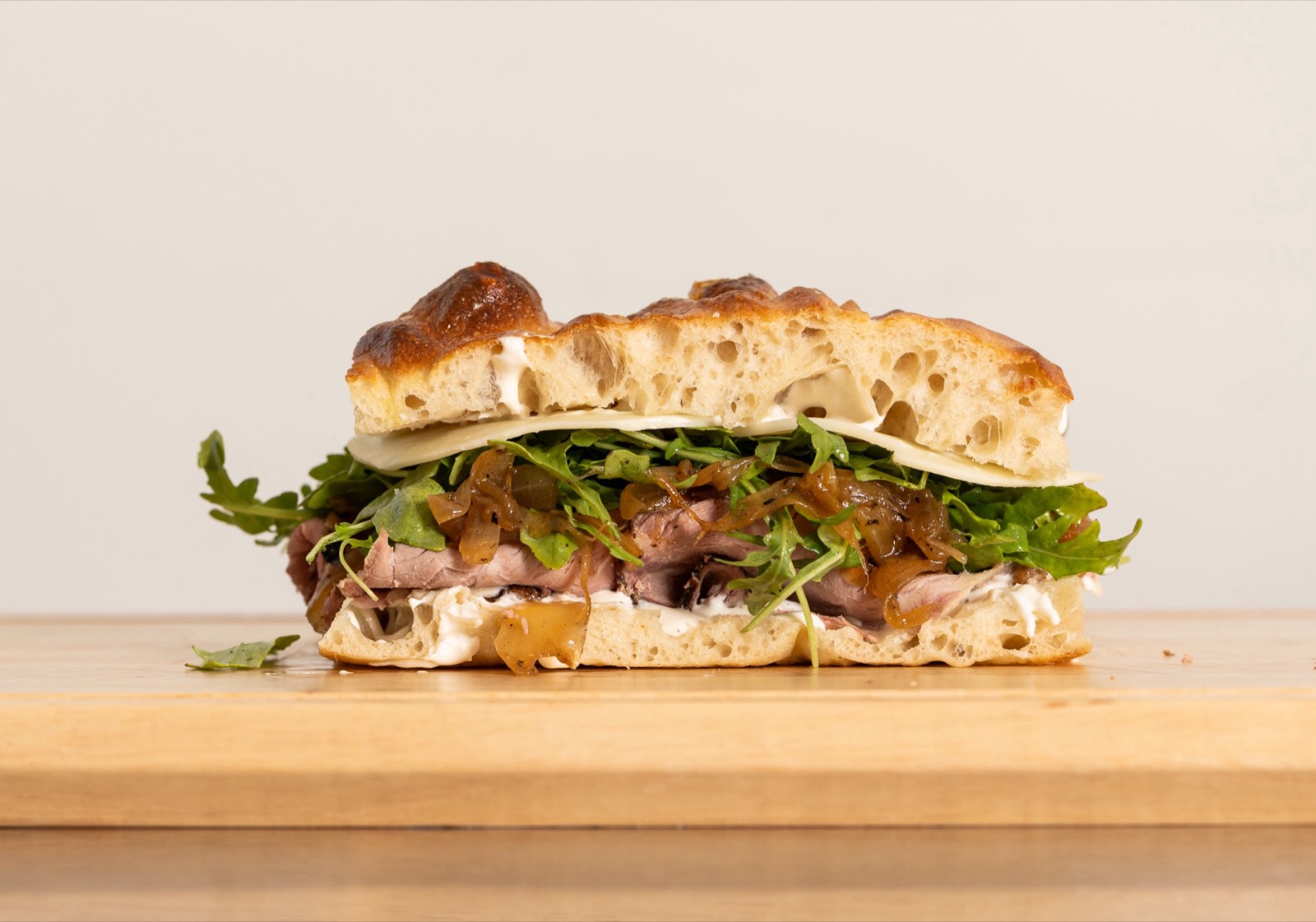 Lunch Money sandwich — roast beef, provolone and horseradish crema on schiacciata